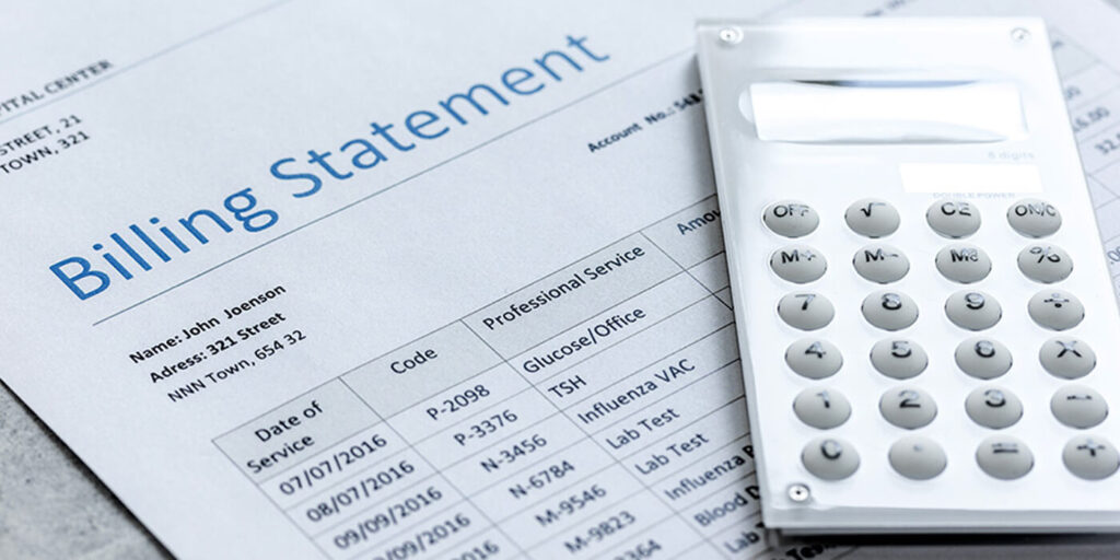 A close-up of a calculator adn a paper with the heading Billing Statement and a list of transactions.