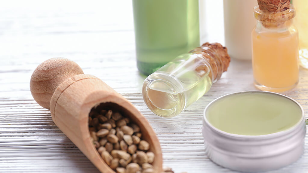A close-up of cannabis products for wellness, including two vials and a wider circular container